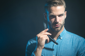 Portrait unshaven man ready to shaving his beard with sharp razor. Tools for barber or shave. Beauty industry and home skin care concept. Copy space for advertise barbershop.