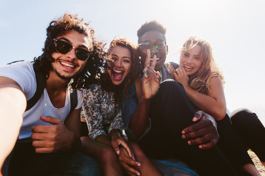 Excited Friends Taking Selfie Outdoors