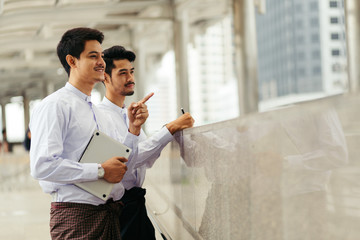 Myanmar peoples talking business in city using and point to target of meeting