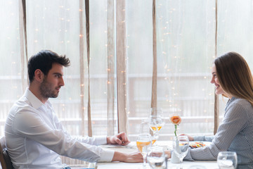 food, christmas, holidays and people concept - smiling couple eating main course at restaurant