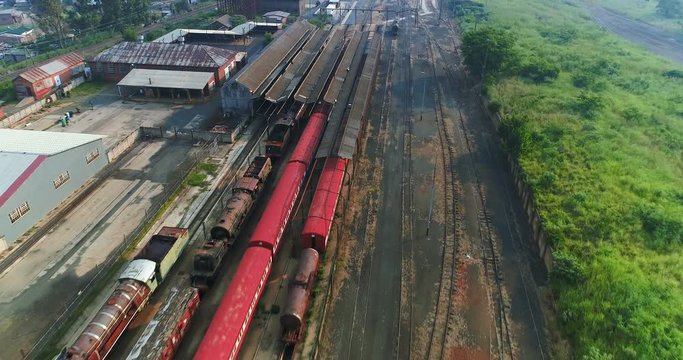 Old train yard long out of commission in rural setting 4K aerial