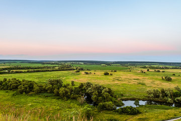 View of green forest-steppe plain. River Koren (Root) valley, typical landscape of Belgorod region, Russia. Evening time.