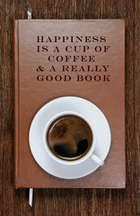 A book with a motivational quote and a cup of coffee