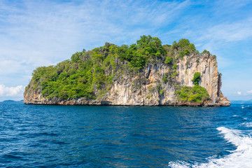 Naklejka premium The limestone rock and islet Goh Dorkmai or Koh Dok Mai, on the way to the Phi Phi islands in the Andaman sea