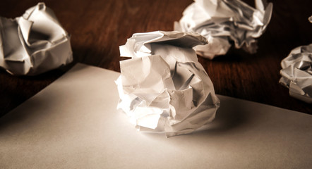 still life of paper and a crumpled paper on a table