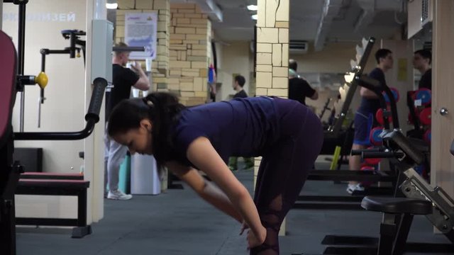 Girl stretches her back to the gym