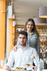 food, christmas, holidays and people concept - smiling couple eating main course at restaurant