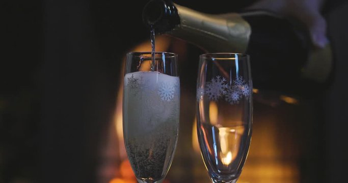  00:00 | 00:17 1&times;  One winter evening a couple sitting in front of the fireplace relaxing, drinking a glass of champagne and making toast to celebrate while enjoying the warmth of the fireplace.