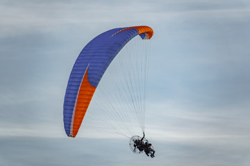 Two unrecognizable persons in paragliding