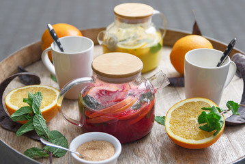 orange tea with ginger and raspberries on a wooden background