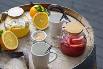 orange tea with ginger and raspberries on a wooden background