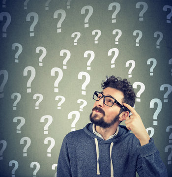 Thoughtful confused man has too many questions and no answer