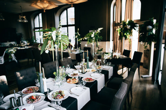 Beautiful black Wedding table decoration with fresh flowers in the restaurant