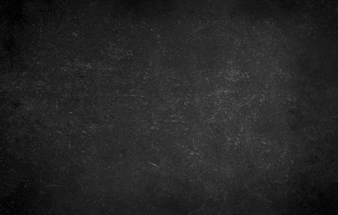 Black gray background of school blackboard monochrome texture. Vignetted aged texture background.