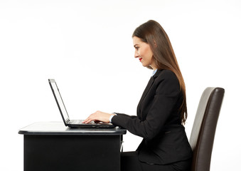 Young businesswoman at her desk with a laptop