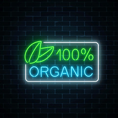 Neon 100 percent organic production sign on dark brick wall background. Natural cosmetics glowing advertising symbol.
