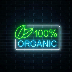 Fototapeta premium Neon 100 percent organic production sign on dark brick wall background. Natural cosmetics glowing advertising symbol.
