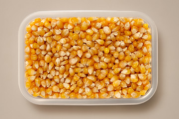 Whole Grains. Top View of Healthy grain foods in a White bowl on grey background with Real Shadow. Corn.