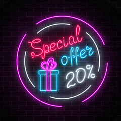 Glowing neon banner of big sale sign on dark brick wall background. Special offer symbol.
