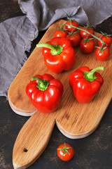 Sweet red pepper with cherry tomatoes on a cutting board. selective focus.