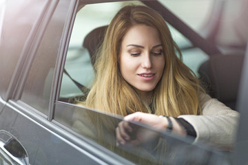 Young woman sitting in a taxi
