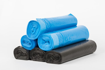 Rolls of disposable trash bags isolated on white background.