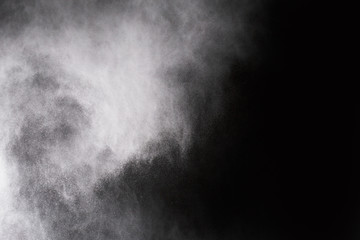 Fototapeta na wymiar White powder on black background.