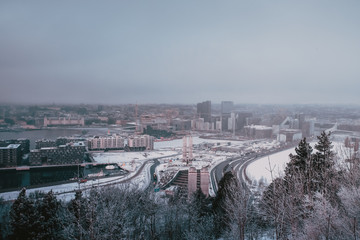 Top view of the modern city of Oslo: Winter and snowy landscape typical of Nordic countries from the top of Ekeberg Park's entrance, Norway