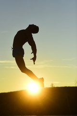 Healthy lifestyle and sport concept. Silhouette of athlete jumping