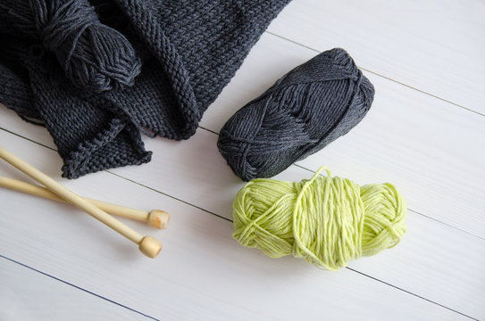 Yarn for knitting on white wooden background. The concept of Hobbies, crafts, the beginning of a new knitting project