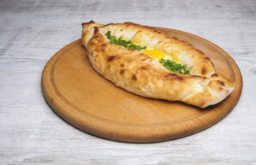 khachapuri on with egg and greens