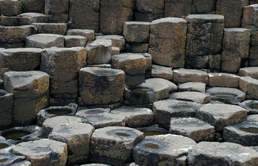 Brown basaltic columns and tops of basaltic prisms (fragment of the Giant’s Causeway in Northern Ireland)