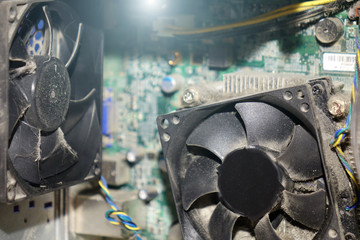Dust on computer PC CPU cooler with motherboard and a fragment of the computer case.
