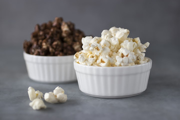 Popcorn in  white bowls on a gray background.