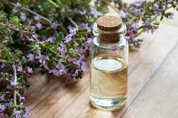 Obraz na płótnie Canvas A bottle of thymus serpyllum (creeping thyme) essential oil