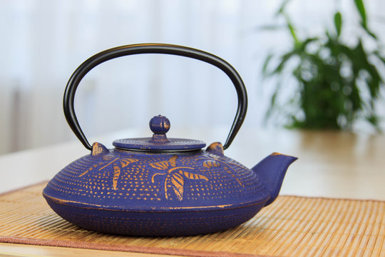 Blue Chinese cast iron teapot. Tea drinking.