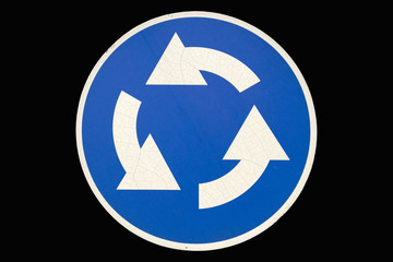 Old round road sign 'Roundable' isolated on black