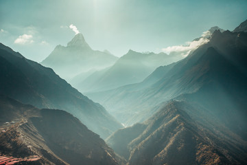The breathtaking panoramic view the mighty misty snow-capped Himalayas and the canyons with the coniferous forests. Nepal. Ideal background for the various kinds of collages and illustrations. - Powered by Adobe