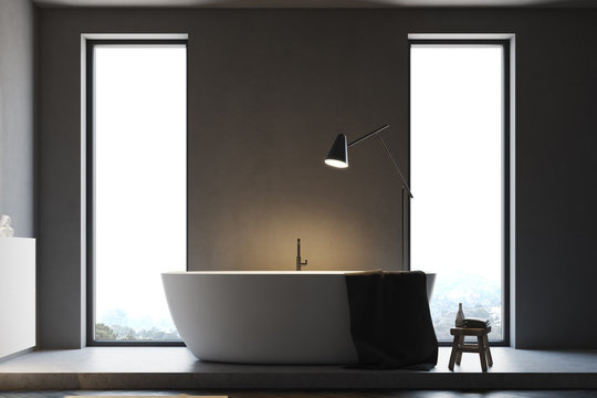 Minimalistic gray bathroom, white tub