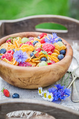 Obraz na płótnie Canvas Cornflakes with yogurt and flowers in sunny day