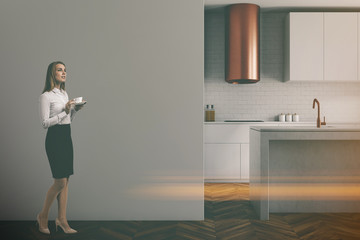 Fototapeta na wymiar Gray wall kitchen, black countertops, woman