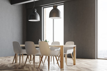 Wooden table with white chairs, windows