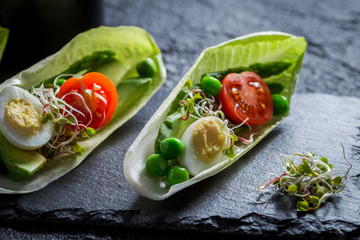 Closeup of salad with quail egg, tomato and avocado