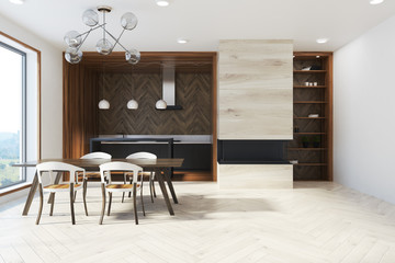 Dark wooden table in panoramic kitchen front
