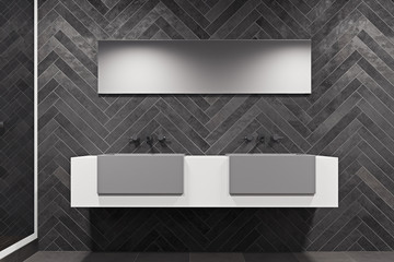 White sink vanity unit in a black bathroom