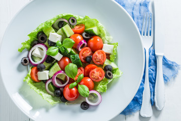 Closeup of fresh Greek salad in white plate