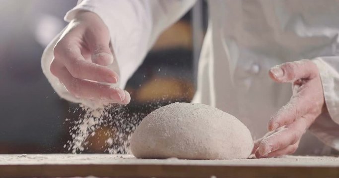 A hand of a farmer takes a handful of yellow flour, to feel the quality and the essence of the raw material. Concept of: tradition, agriculture, flour, love for nature.
