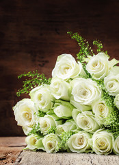 Bouquet of white roses for women's day, wooden background, selective focus