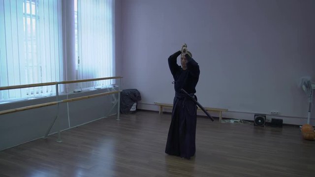 Samurai in Kimono Leads Shadow Fight with the Help of the Catana Sword