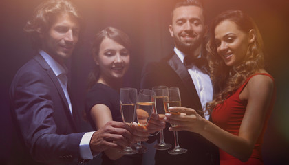 Group of happy smiling friends with glasses